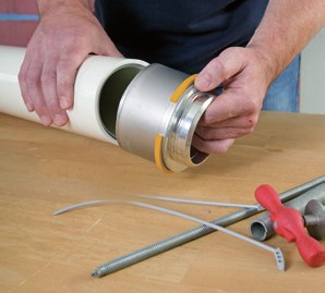 Installing Uponor RS, step 1: press adapter is pushed into the cut and deburred MLC pipe